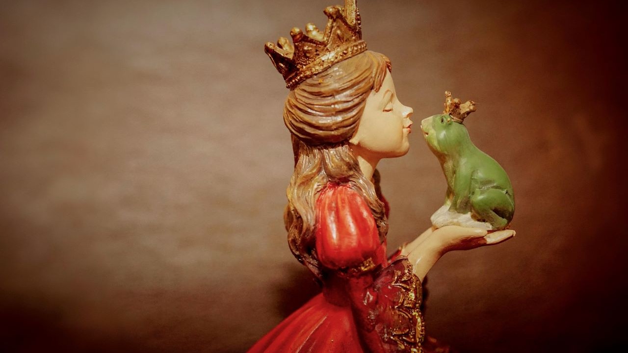 Fairytale scene of a princess kissing a frog as a symbol of transformation