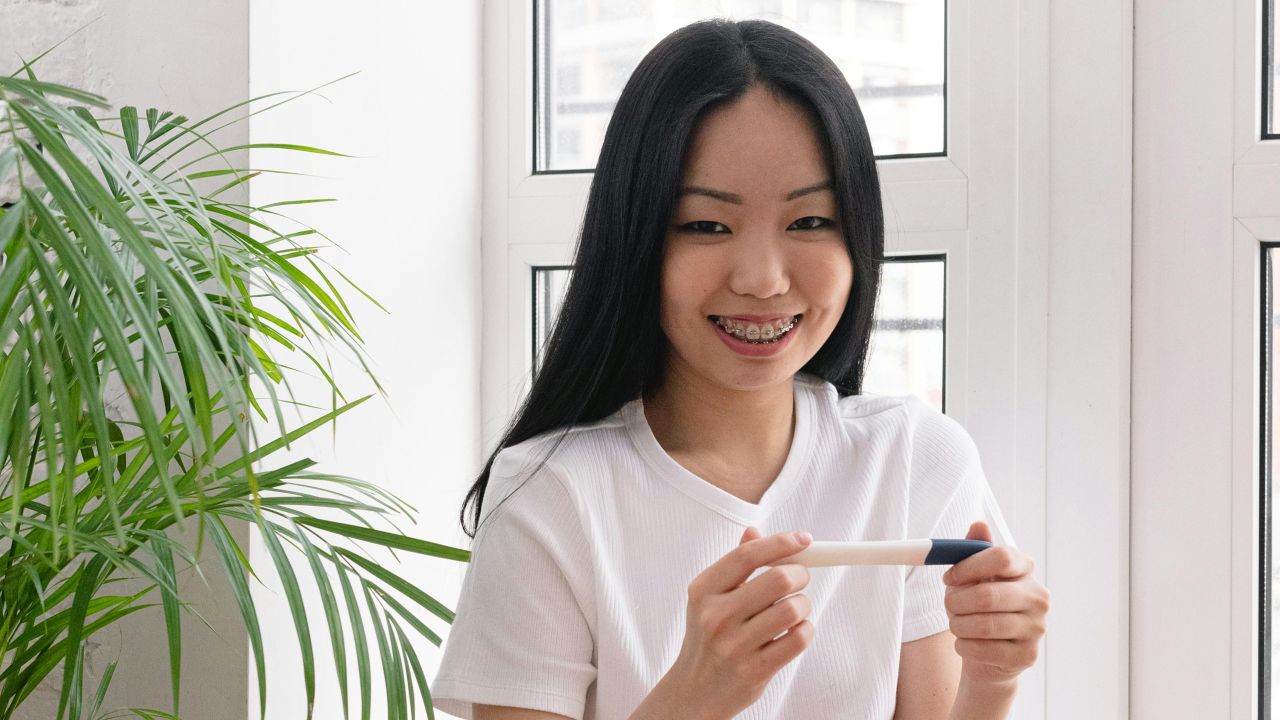 Woman looking calmly at a pregnancy test