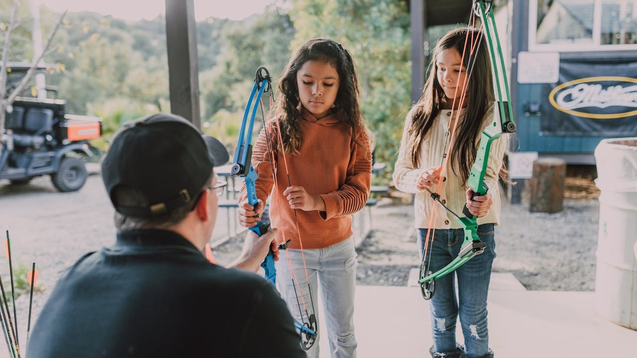 Two children greeting their parent's new partner at the apartment door
